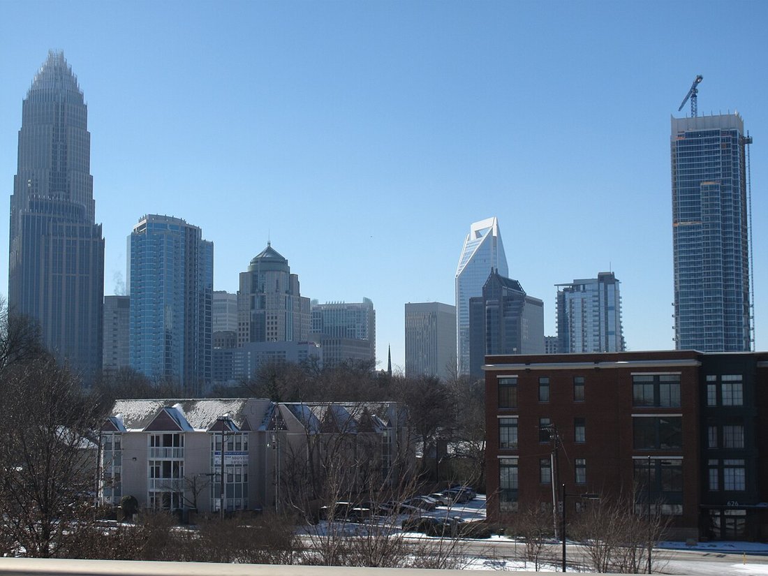 Skyline of Charlotte, North Carolina seen across a low neighborhood